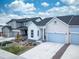 Street view of modern homes with well-maintained lawns and driveways under a bright sky at 195 Silver Rock Trl, Castle Rock, CO 80104
