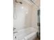 Bathroom with a white tiled shower-tub combination and shower curtain at 10134 Bluffmont Ln, Lone Tree, CO 80124