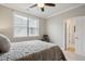 Bedroom with a large window, ceiling fan, neutral walls and carpeting throughout at 10134 Bluffmont Ln, Lone Tree, CO 80124