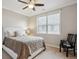 Bedroom with a large window, ceiling fan, neutral walls and carpeting throughout at 10134 Bluffmont Ln, Lone Tree, CO 80124
