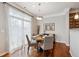 Bright dining area featuring a round table, four chairs, and large windows letting in natural light at 10134 Bluffmont Ln, Lone Tree, CO 80124