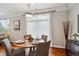 Cozy dining area with hardwood floors, a round table, and sheer curtains for soft light at 10134 Bluffmont Ln, Lone Tree, CO 80124