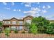 Beautiful two-story home with attractive landscaping and a retaining wall, set against a bright blue sky at 10134 Bluffmont Ln, Lone Tree, CO 80124