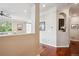 Hallway with hardwood floors, white walls, archway, and views into other rooms at 10134 Bluffmont Ln, Lone Tree, CO 80124