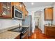 Contemporary kitchen with stainless steel appliances, granite counters, and rich wood cabinets at 10134 Bluffmont Ln, Lone Tree, CO 80124