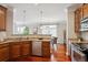 Open-concept kitchen featuring granite countertops, stainless appliances, and hardwood floors near dining area at 10134 Bluffmont Ln, Lone Tree, CO 80124