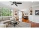 Open-concept living space with a dining area, hardwood floors, and plenty of natural light at 10134 Bluffmont Ln, Lone Tree, CO 80124