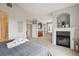 Expansive main bedroom boasting a cozy fireplace, a stylish wet bar, and elegant built-in shelving at 10134 Bluffmont Ln, Lone Tree, CO 80124