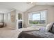Comfortable main bedroom with fireplace, complemented by a large window that offers neighborhood views at 10134 Bluffmont Ln, Lone Tree, CO 80124