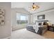Spacious main bedroom with vaulted ceiling, ceiling fan and expansive window offering neighborhood views at 10134 Bluffmont Ln, Lone Tree, CO 80124