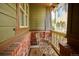 Cozy porch with brick accents, a table with two chairs, and a view of the outdoors at 10134 Bluffmont Ln, Lone Tree, CO 80124