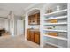 Well-appointed sitting area featuring a wet bar and built-in shelving, ideal for relaxation and quiet enjoyment at 10134 Bluffmont Ln, Lone Tree, CO 80124
