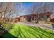 Landscaped backyard featuring a well, patio, and artificial turf for easy maintenance at 2317 Elmira St, Aurora, CO 80010