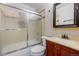 Clean bathroom with a tiled shower, framed mirror, and vanity sink at 2317 Elmira St, Aurora, CO 80010