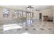 Bright living room with decorative tile flooring, recessed lighting, and access to the backyard through sliding glass doors at 2317 Elmira St, Aurora, CO 80010