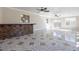 Spacious living room featuring elegant tile floors, ceiling fans, and natural light from multiple windows at 2317 Elmira St, Aurora, CO 80010
