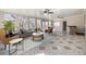 Spacious living room with large windows, ceiling fans, and stylish tile flooring at 2317 Elmira St, Aurora, CO 80010