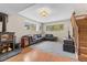 Spacious basement living room with a fireplace, carpet, a leather couch, and large windows at 30313 Arena Dr, Evergreen, CO 80439