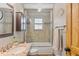 Bright bathroom features a shower over tub with tile surround, updated vanity, and unique design details at 30313 Arena Dr, Evergreen, CO 80439
