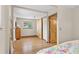 This bedroom features hardwood floors, ample closet space with wooden sliding doors, and view of green foliage at 30313 Arena Dr, Evergreen, CO 80439