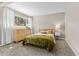 Serene bedroom featuring a large window, hardwood floors, a queen-sized bed, and simple decor at 30313 Arena Dr, Evergreen, CO 80439