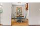 Cozy dining room featuring a round wooden table, hardwood floors, and bright blue chairs at 30313 Arena Dr, Evergreen, CO 80439