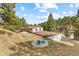 Exterior aerial view of the property featuring the backyard with a patio, seating area, and gazebo at 30313 Arena Dr, Evergreen, CO 80439