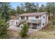 Charming exterior view of a two story house with a deck, a large lot, and a three car garage at 30313 Arena Dr, Evergreen, CO 80439