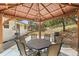 An interior view of a gazebo with an outdoor dining table and chandelier, ready for outdoor dining at 30313 Arena Dr, Evergreen, CO 80439