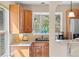 This kitchen features wooden cabinets, granite countertops, and a bay window with great wooded views at 30313 Arena Dr, Evergreen, CO 80439