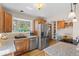 Kitchen area featuring granite countertops, stainless steel appliances, wood cabinets, and an attached dining space at 30313 Arena Dr, Evergreen, CO 80439