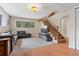 Spacious living room with staircase, large window, and plush carpeting, ideal for comfortable living at 30313 Arena Dr, Evergreen, CO 80439
