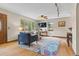 Comfortable living room with a large window offering natural light, hardwood floors, and stylish decor at 30313 Arena Dr, Evergreen, CO 80439