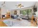 Bright living room with hardwood floors, comfortable seating, large windows, and stylish decor at 30313 Arena Dr, Evergreen, CO 80439