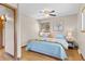 Comfortable bedroom with a ceiling fan, hardwood floors, a queen-sized bed, and a window view at 30313 Arena Dr, Evergreen, CO 80439