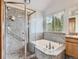 Bathroom featuring granite countertops, a shower, and a bathtub with a view to the outdoors at 9412 La Quinta Way, Lone Tree, CO 80124