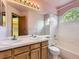 Bathroom with double sinks, a bathtub, and a shower featuring white tile at 9412 La Quinta Way, Lone Tree, CO 80124