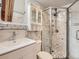 Modern bathroom featuring a glass shower, floating sink and vanity, and marble detail at 9412 La Quinta Way, Lone Tree, CO 80124