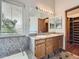 Bright bathroom featuring double sinks with granite countertops, large mirror, and tub at 9412 La Quinta Way, Lone Tree, CO 80124