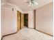 Empty bedroom with light carpet and a closet door, bathed in sunlight at 9412 La Quinta Way, Lone Tree, CO 80124