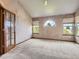 Bright bedroom with vaulted ceiling, neutral carpet, and multiple windows allowing for lots of natural light at 9412 La Quinta Way, Lone Tree, CO 80124