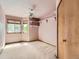 Carpeted bedroom with a ceiling fan, closet and window with view to outdoors at 9412 La Quinta Way, Lone Tree, CO 80124