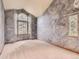 Large bedroom with unique gray textured walls, plush carpet, and large windows at 9412 La Quinta Way, Lone Tree, CO 80124