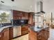 Kitchen with wood cabinets, granite countertops, stainless steel appliances, and island at 9412 La Quinta Way, Lone Tree, CO 80124