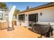 A cozy back patio with wooden deck, outdoor lighting and grill area, ideal for entertaining guests at 1288 Gambel Oaks Dr, Elizabeth, CO 80107
