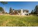 Spacious backyard featuring a well-maintained lawn and a wooden deck area at 1288 Gambel Oaks Dr, Elizabeth, CO 80107