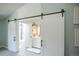 Stylish bathroom with patterned floor tiles and barn-style sliding doors, a contemporary design at 1288 Gambel Oaks Dr, Elizabeth, CO 80107