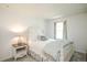 Comfortable bedroom with a cozy bed, side table with lamp and bright window views at 1288 Gambel Oaks Dr, Elizabeth, CO 80107