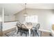 Elegant dining room features a wooden table with black chairs and a modern pendant light fixture at 1288 Gambel Oaks Dr, Elizabeth, CO 80107