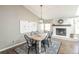 Dining and living space showcasing a rustic table and chairs alongside a fireplace and decorative wall art at 1288 Gambel Oaks Dr, Elizabeth, CO 80107